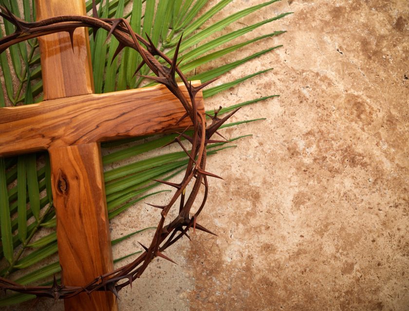 Crown of thorns, cross and palm leaves. Palm sunday and easter day concept.