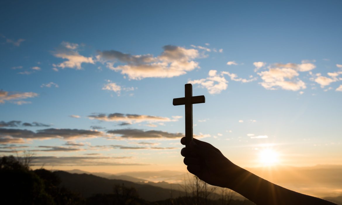 Silhouette of Hand hold cross of God