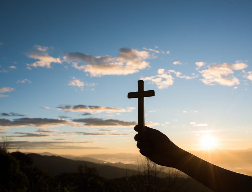 Silhouette of Hand hold cross of God